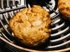 A close-up of a golden-brown baked food in an air fryer.
