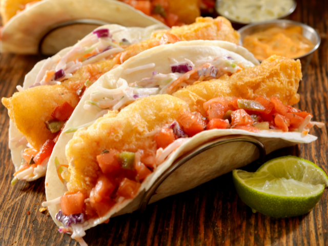 Delicious fish tacos with fresh salsa and lime.