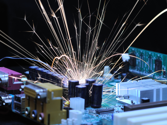 A close-up of a spark flying from an electrical component.