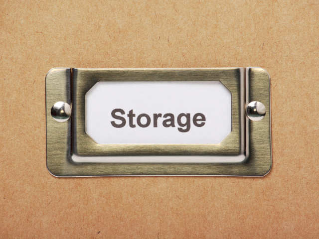 Close-up of a metal label holder on a box labeled “Storage.”